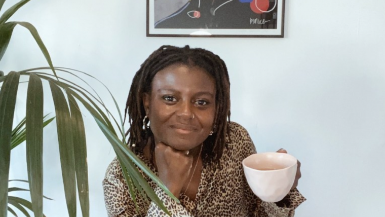 Priscilla drinking a coffee while working from home